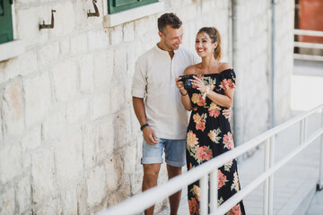 Canvas Print - Couple Walking And Using Digital Camera At Summer Day