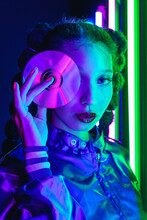 Ethnic Woman In Retro Outfit With CD In Studio With Neon Lights