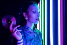 Ethnic Woman In Retro Outfit With CD In Studio With Neon Lights