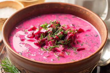 Wall Mural - Cold borscht or Holodnik, traditional summer beet soup in ceramic bowl on wooden background