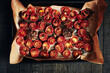 Oven roasted cherry tomatoes on an oven tray.