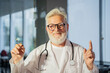 © de Art - old doctor holds a syringe with a vaccine in his hands as a symbol of vaccination