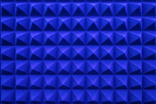 rows of acoustic music soundproof foam pyramid panel with blue lighting.