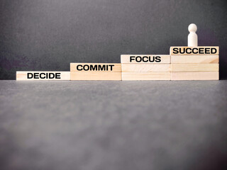 Wall Mural - Inspirational and Motivational Concept - DECIDE COMMIT FOCUS SUCCEED text on wooden blocks background. Stock photo.