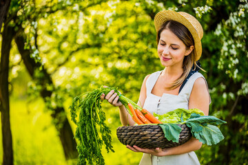 young woman with vegetable basket in a garden