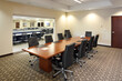 Modern conference room boardroom with long desk and chairs