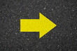 © sallies - Asphalt with a yellow right arrow sign. Tarmac road with right arrow sign