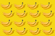 Many bananas isolated on a yellow background. Abstract food background concept. Copy and clone bananas for the pattern. Copy space for design or edit