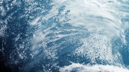 Aufkleber - A cinematic rendering of planet Earth during sunrise as view from space with vibrant blue atmosphere and cloudy sky showing continents below