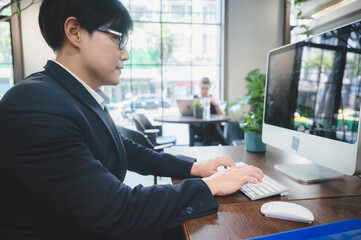 Wall Mural - confident professional businessman working with laptop in modern business office workplace, executive manager man with computer technology, male businessman entrepreneur startup