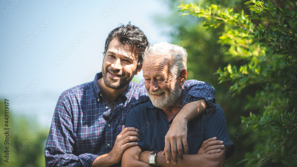 caucasian senior father and adult son are hugging together at home, generation family are happy with people love, male mature, old person man, elderly grandfather smiling living at the house - obrazy, fototapety, plakaty 
