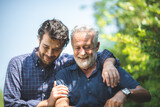 Fototapeta Na ścianę - caucasian senior father and adult son are hugging together at home, generation family are happy with people love, male mature, old person man, elderly grandfather smiling living at the house