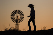 Cow Girl And Windmill At Sunset