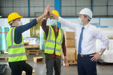 Engineering people are wearing face mask happy in modern factory , industrial successful and teamwork concept