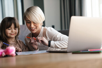 Canvas Print - Mother helping her daughter with her homework