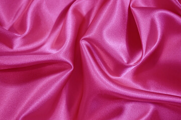 Wall Mural - Beautiful bright pink silk satin background. Wavy soft folds. Elegant fabric background with copy space for design. Web banner.