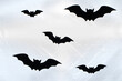 Figures of black bats on a white background for Halloween.