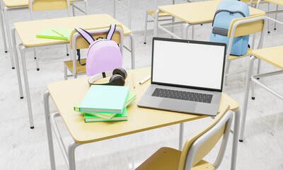 Wall Mural - laptop on a school desk in a classroom with books and supplies around