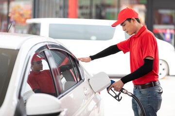 Wall Mural - male worker refueling vehicle or car at gas station