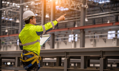 Engineer under inspection and checking construction process railway switch and checking work on railroad station .Engineer wearing safety uniform and safety helmet in work.