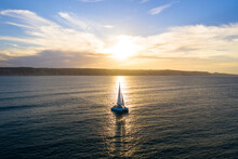 Catamaran Sailing At Sunset