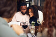 © Southworks - Young couple looking at phone in wine bar