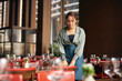 © Southworks - Female restaurant owner setting tables