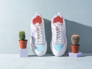 Canvas Print - White sneakers with sequins and cactus plant on turquoise background