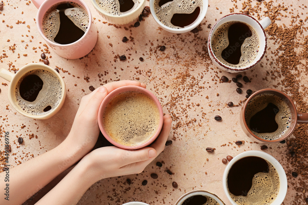 Female hands and cups of coffee on color background