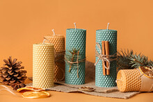 Composition With Handmade Wax Candles On Color Background
