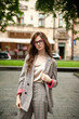 © alipko - Young woman in clear eyeglasses on the street