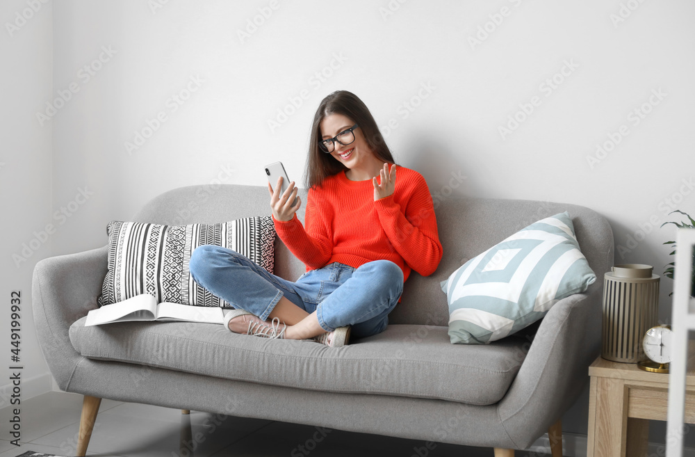 Young woman video chatting at home