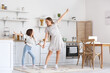 © Pixel-Shot - Young woman and her little daughter dancing in kitchen