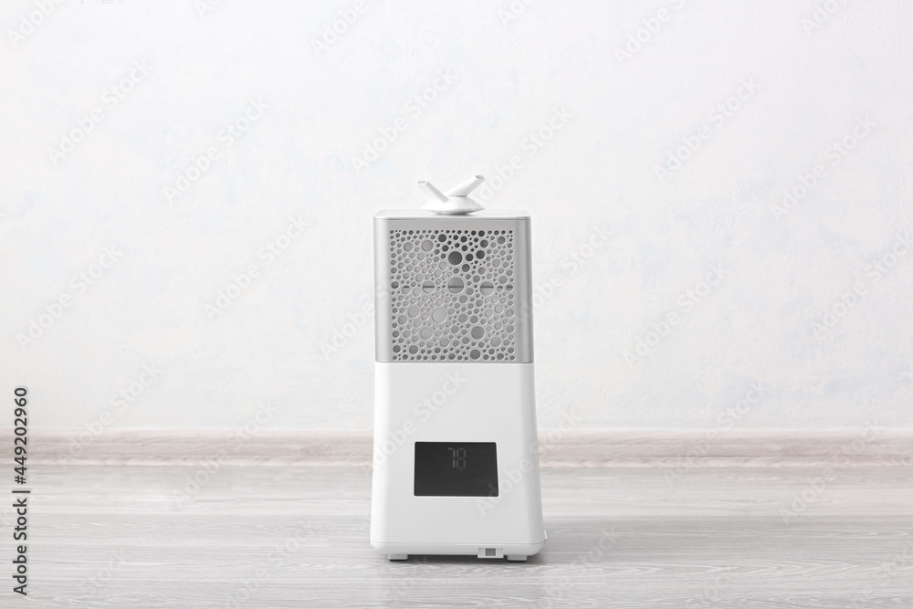 Modern humidifier on floor in room