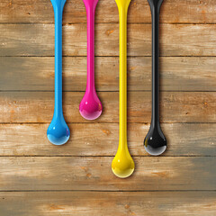 Wall Mural - cmyk ink drops on old wooden square background