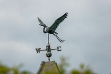 Iron Weathervane In The Shape Of A Stork With A Blurred Background An Instrument Used For Showing The Direction Of The Wind