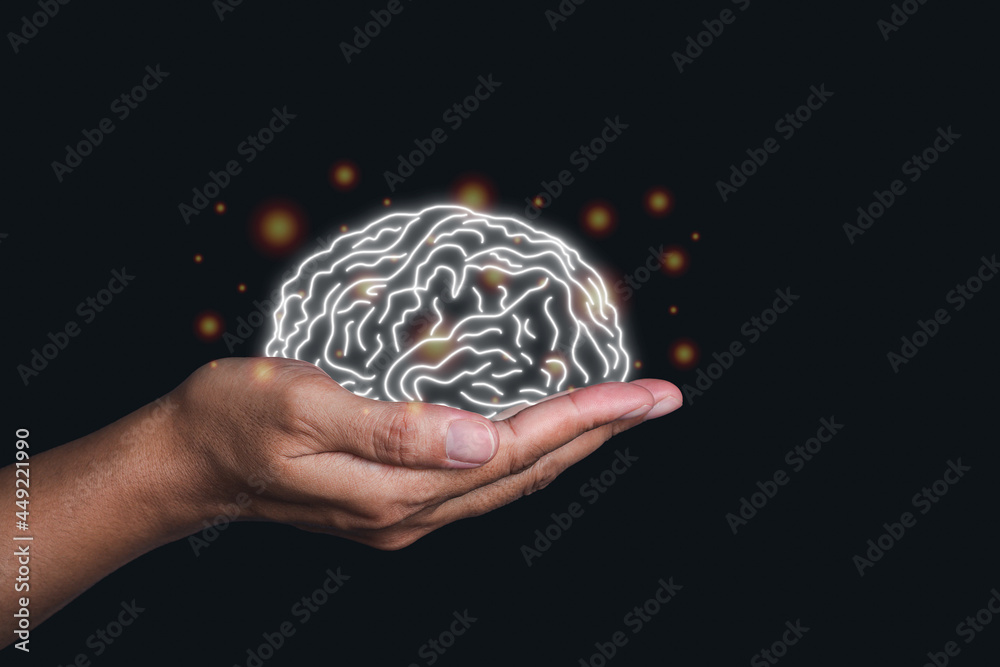 Hand holding a digital image of the brain in the palm on black ...
