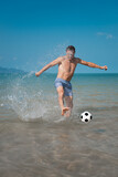 Fototapeta Sport - sports man playing with ball on beach