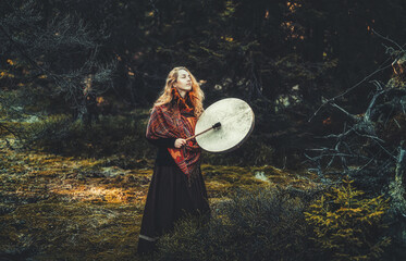 Poster - beautiful shamanic girl playing on shaman frame drum in the nature.