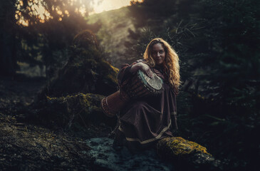 Fototapete - beautiful shamanic girl playing on drum in the nature.