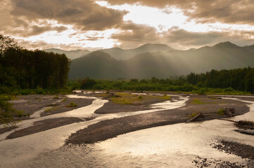 Wall Mural - Nooksack River Sunrise. Light rays streaking across the North Cascade Mountains during a lovely sumertime sunrise. 