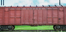 Large Container On A Railway Platform In Daylight. Freight Train On Railway Tracks.
