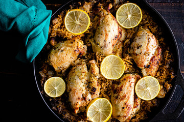 Wall Mural - Greek Chicken and Lemon Rice Served in a Cast Iron Skillet: Boneless Skinless chicken thighs and rice in a cast iron pan