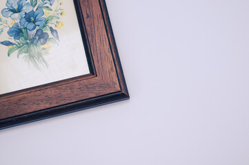 Sticker - Picture frame with blue painted flowers isolated on a light gray background