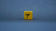 © tarasari - Wooden block with number 7. Yellow color on dark background