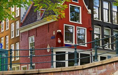 Amsterdam Netherlands dancing houses over river Amstel landmark besides Grachten canals with city skyline old town historic architecture Delft style