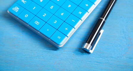 Sticker - Calculator and pen on the blue background.