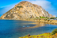 Kayak Paddlers Enjoy The View Of Morro Rock In Morro Bay On The California Coast