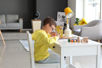 Wall Mural - Cute little boy painting at home