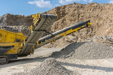 Wall Mural - Heavy and mobile machinery in a quarry to transform stone into construction material